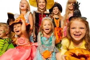 Happy kids wearing Halloween costumes close-up